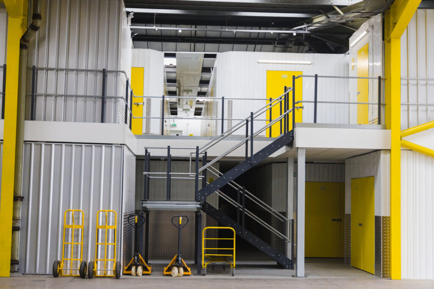 Mezzanine, stairs and trolleys inside the indoor storage facility