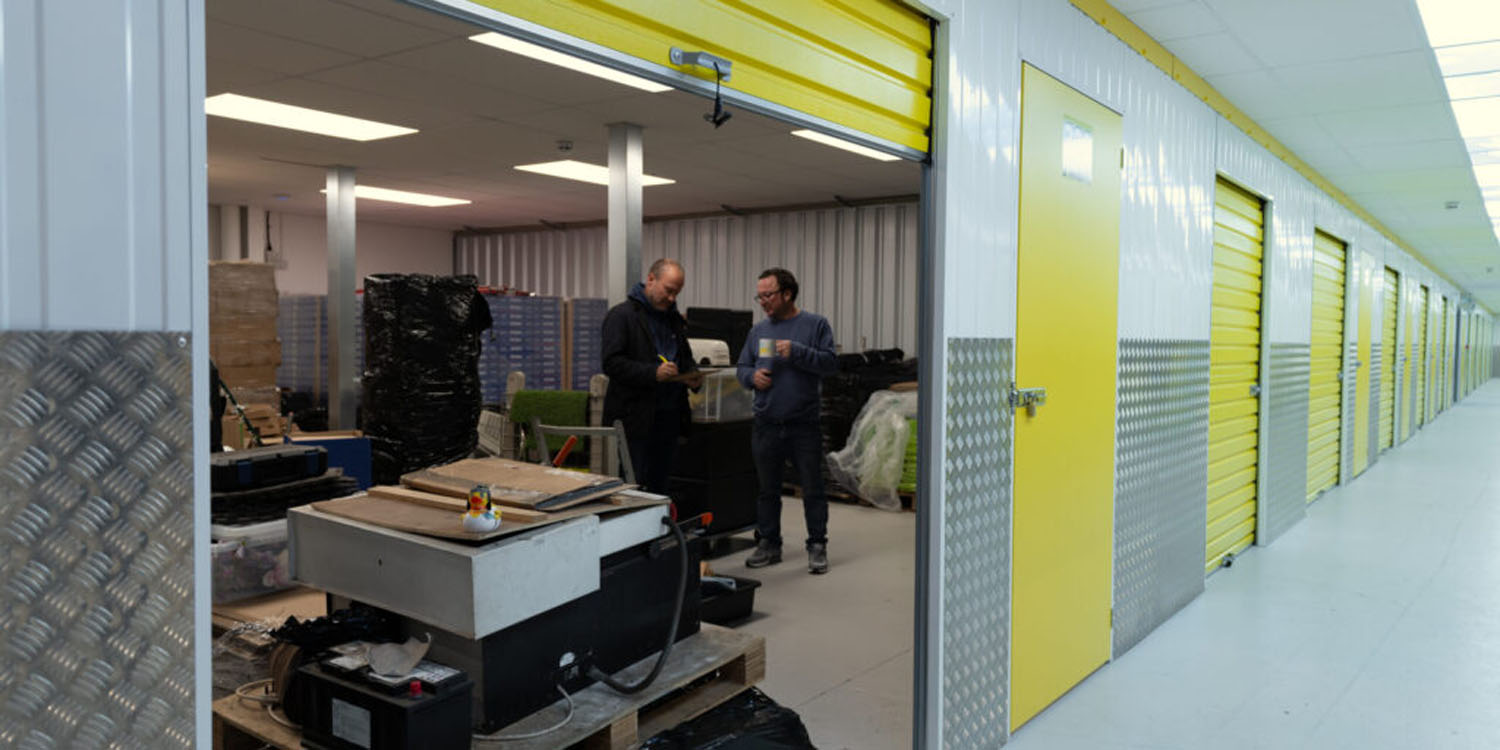 Business customers working inside a large indoor storage unit