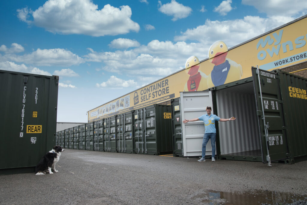 Customer opening a green storage container in the outdoor yard