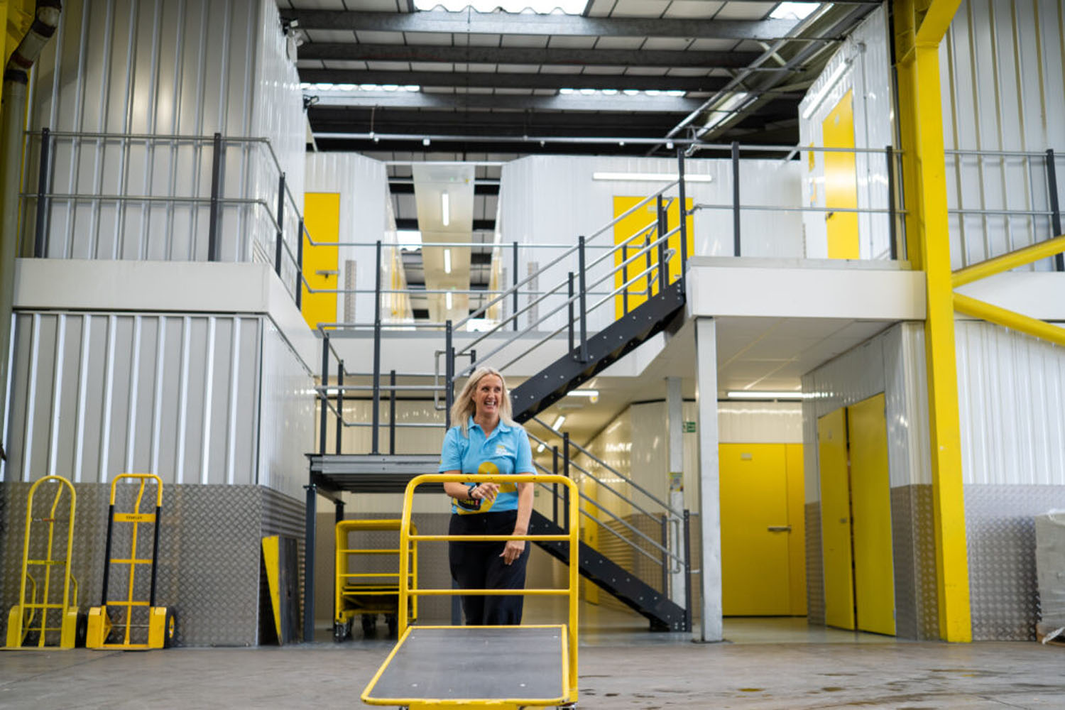 Team member with a platform trolley inside the indoor storage facility